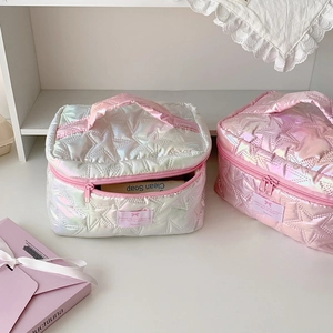 Detailed star-quilted cosmetic bags in iridescent pearl white and soft pink shades