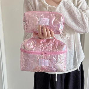 Detail of pink metallic makeup bags with star quilting and top handle set