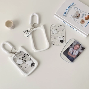 Close-up of clear cat photocard holder with white spring keychain and metal clip