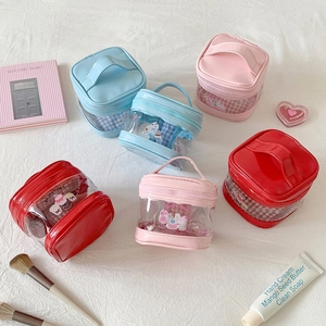 Mini transparent PVC cartoon makeup bags in blue, pink, and red with portable handles