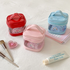 Close-up of cute transparent makeup bags with checkered patterns and sweet slogans