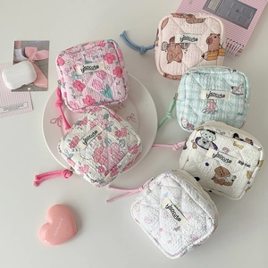 Flat lay of quilted cotton coin purses in six cute patterns with wristlet straps