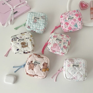Detailed top view of assorted floral and animal quilted sanitary storage pouches for women