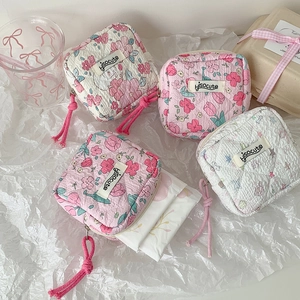 Flat lay of four floral quilted fabric pouches for cosmetics and small accessories