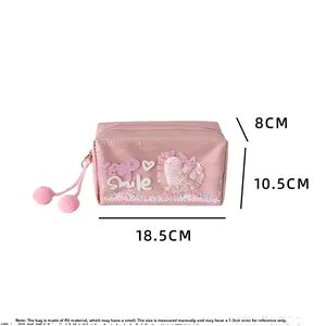 Detailed view of pink sequin heart cosmetic bag with size 18.5x10.5x8cm and pompom zip