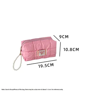 Pink quilted cloud makeup bag with pearl handle and 19.5cm dimensions detail