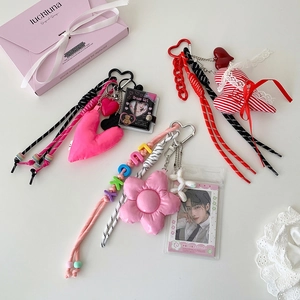 Flat lay of pink Y2K plush flower and heart pendants with transparent photo card holders