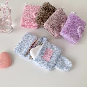 Detail of colorful leopard print plush wallets showing interior compartments and snap buttons
