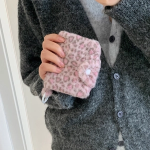 Plush pink leopard print card wallet with snap button and clip held by model
