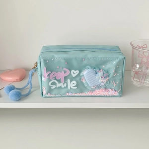Detail of light blue pencil case with pink star glitter liquid and Keep Smile print
