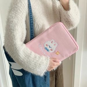Detail of pink corduroy iPad sleeve with cute rabbit embroidery and zip closure