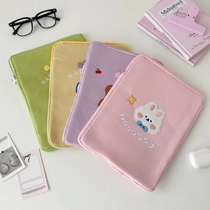 Detail of colorful corduroy iPad sleeve with cute animal embroidery and macaron colors