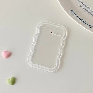 Detail of transparent wavy edge card holder with red heart and White lettering