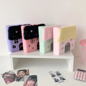 Detail of four colorful plush house-shaped photo card albums with cute embroidery decor
