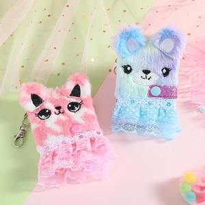 Close-up of plush cartoon cat and bear coin purses with lace skirts and metal keychains