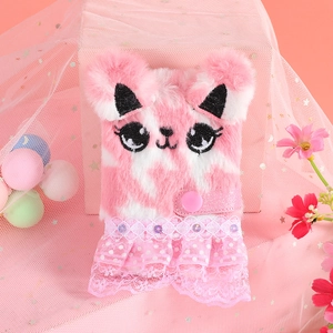 Detail of pink plush notebook cover with faux fur ears and delicate lace trim accents