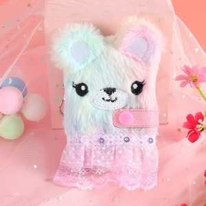 Detail of plush bear notebook featuring macaron fur, lace skirt and metallic lobster clasp