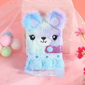 Detail of plush bear notebook featuring gradient faux fur and blue polka dot lace trim