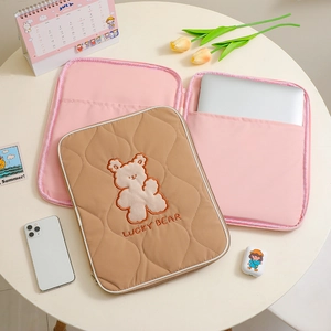 Quilted cartoon bear laptop sleeve with pink interior and lucky bear embroidery