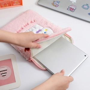 Detail showing a pink plush iPad sleeve with white bear patch and soft protective lining