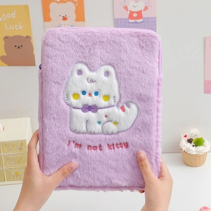 Detail of purple plush tablet sleeve featuring cute cartoon embroidery and soft texture