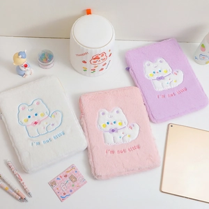 Detailed view of plush tablet sleeves in white, pink and purple with cat embroidery