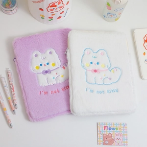 Detail of plush cat tablet sleeve with embroidery and soft faux fur material