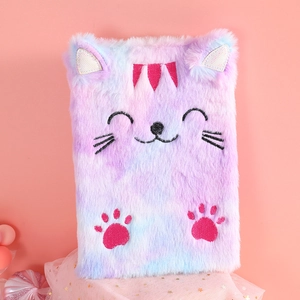Detail of plush cat notebook with pink-purple gradient fur and embroidered kitty face