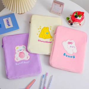 Detailed embroidery on colorful plush 11-inch tablet sleeves with smooth zipper closure