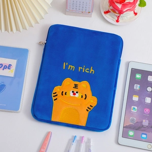 Blue plush laptop sleeve featuring an embroidered tiger and I am rich text detail