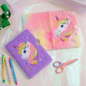 Detail of plush unicorn A5 notebooks with metal locks and vibrant embroidery in pink and purple