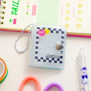 Macro detail of transparent PVC mini photo card holder with heart patterns and bead chain