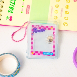 Close-up of pink checkered mini PVC photo album with beaded chain and cute English text