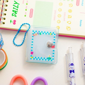 Close-up of mini transparent 2-inch blue photocard binder with cute metal chain