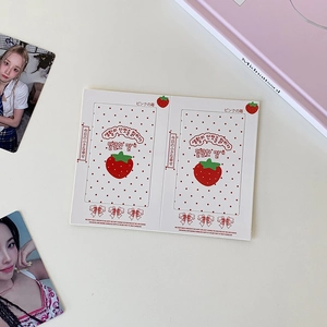 Detail view of strawberry printed photocard holders for 3-inch polaroid photos decoration