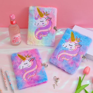 Three plush tie-dye unicorn journals with gold crown embroidery and heart locks