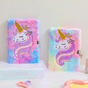 Detailed view of plush unicorn notebooks with metal locks and fluffy rainbow faux fur