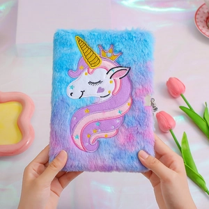 Detail showing the plush unicorn diary cover with embroidery, crown, and secure metal lock