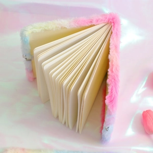 Detail of plush rainbow notebook featuring lined paper and high-quality metal buckle