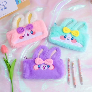 Detail of plush rabbit pencil cases with soft fur, embroidery, and sequin ear accents