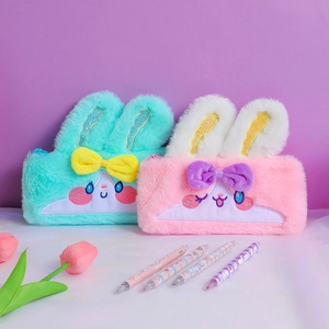 Detail of plush rabbit pencil cases with sequined ears and cute embroidered faces