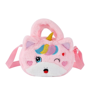 Close-up of pink plush unicorn bag featuring golden horn and colorful cloud embroidery