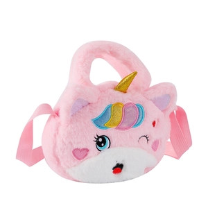 Macro detail of plush unicorn bag showing embroidered eyes and golden sequin horn