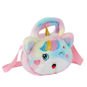 Close-up of rainbow plush unicorn bag featuring fine embroidery and golden horn detail