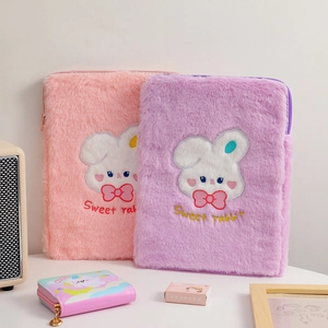 Close-up of plush tablet sleeve featuring cute bunny embroidery and soft faux fur texture
