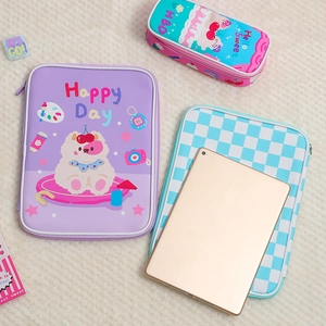 Flat lay of purple PU leather tablet sleeve and stationery bag with cartoon dog prints