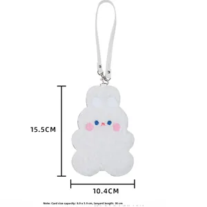 Close-up of white plush bunny card holder with dimensions 15.5x10.4cm and lanyard