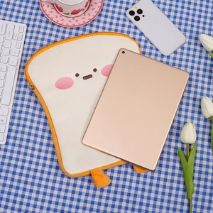 Detail of plush toast-shaped 11 inch iPad sleeve with cute embroidery and orange zipper