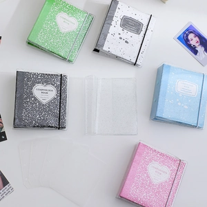 Detailed flat lay of three-ring mini photo albums in various colors and textures