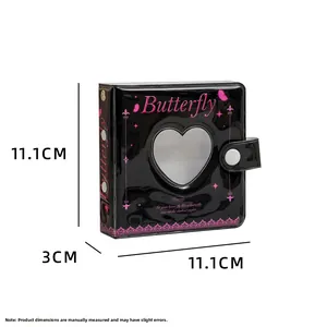 Detail view of black heart cutout mini photo album with butterfly design and button closure